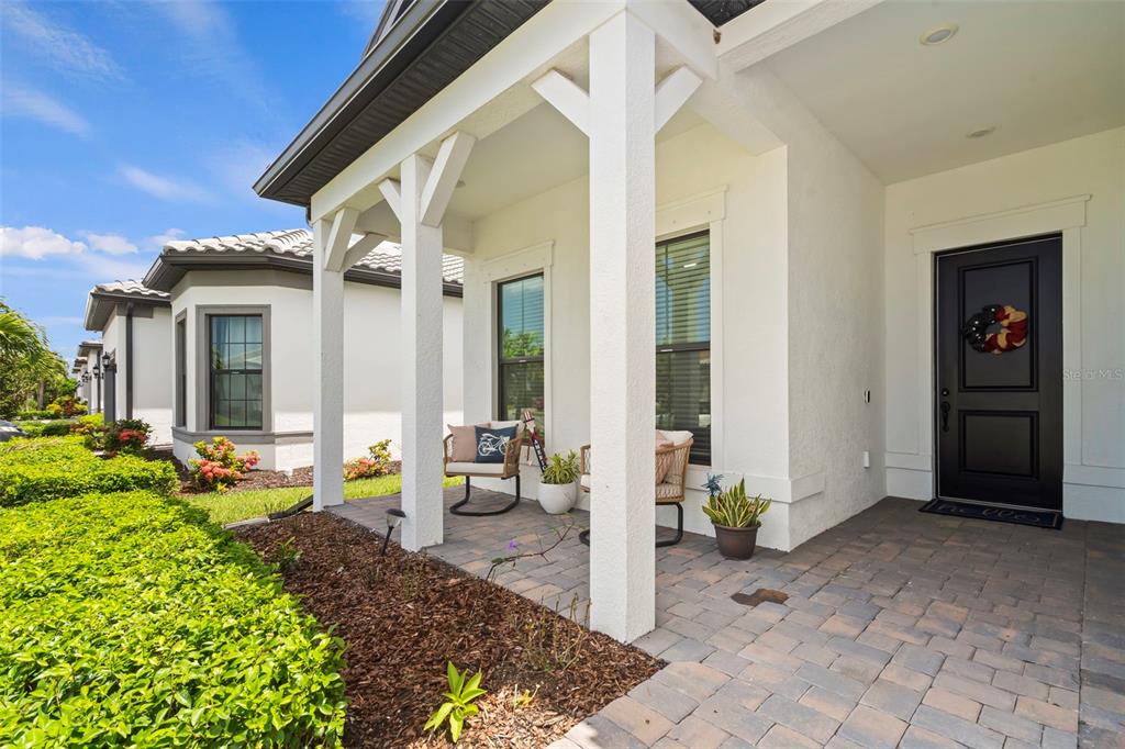 14560 Eagle Branch Drive Nokomis, FL 34275 - Photo 3 of 65 a view of a patio with table and chairs and potted plants