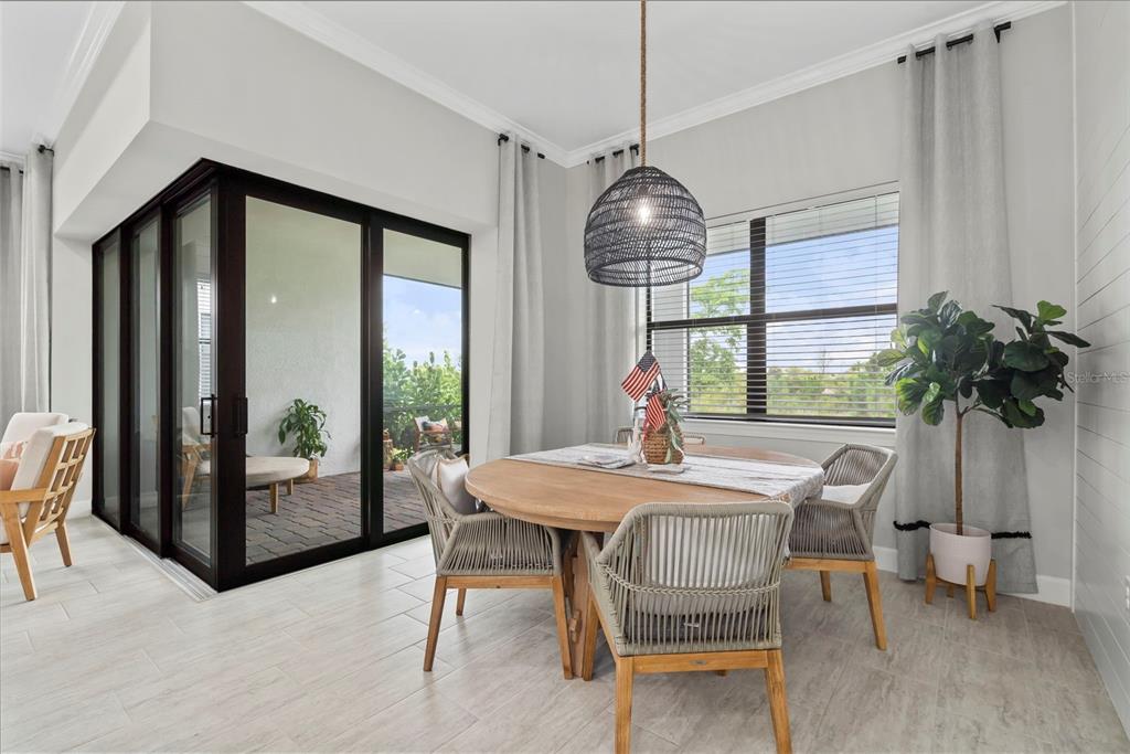 14560 Eagle Branch Drive Nokomis, FL 34275 - Photo 32 of 65 a dining room with furniture a chandelier and window