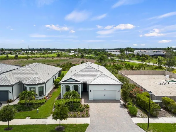 an aerial view of a house with a yard