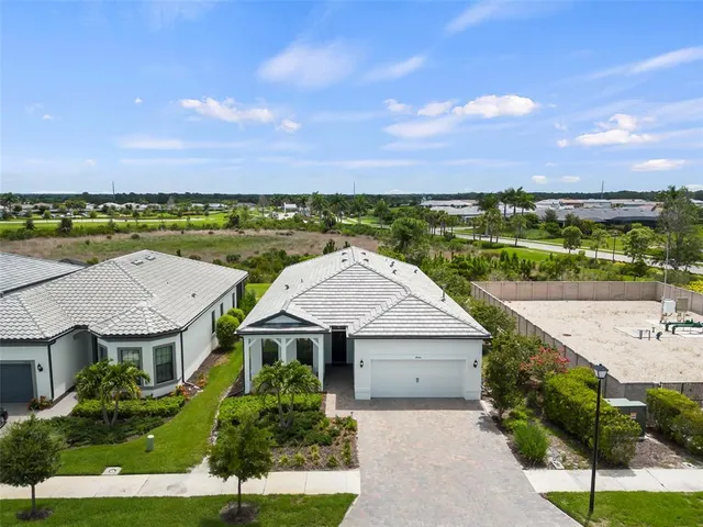an aerial view of a house with a yard