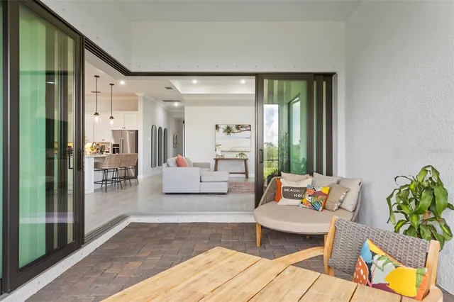 an aerial view of a house with a yard swimming pool and outdoor seating