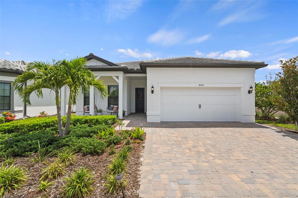 14560 Eagle Branch Drive Nokomis, FL 34275 - Photo 47 of 65 a front view of a house with a yard and garage