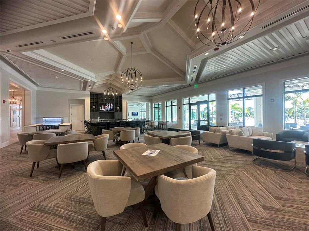 14560 Eagle Branch Drive Nokomis, FL 34275 - Photo 64 of 65 a living room with furniture kitchen view and a chandelier