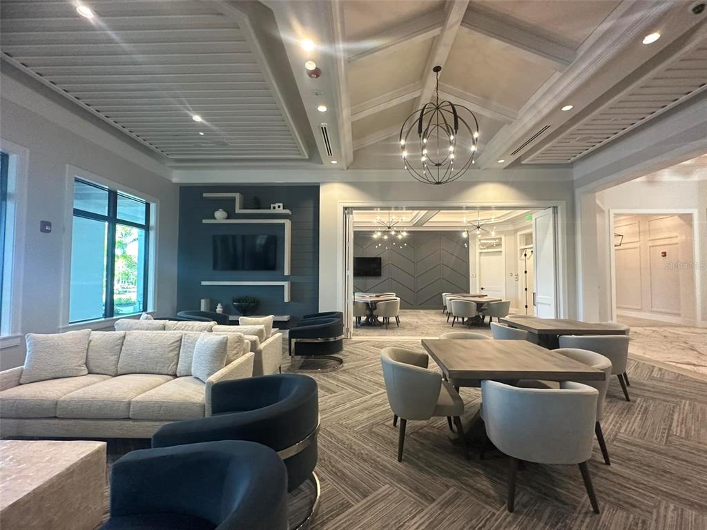 14560 Eagle Branch Drive Nokomis, FL 34275 - Photo 65 of 65 a living room with patio furniture and a chandelier