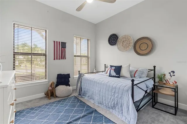 a bedroom with a bed and a lamp on dresser