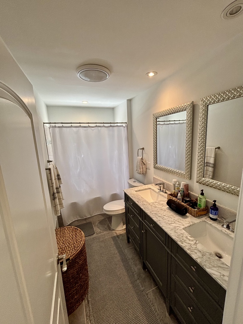 1237 Heatherfield Lane Glenview, IL 60025 - Photo 21 of 33 a bathroom with a double vanity sink and a mirror