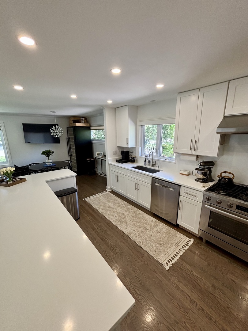 1237 Heatherfield Lane Glenview, IL 60025 - Photo 8 of 33 a kitchen with stainless steel appliances kitchen island granite countertop a sink counter top space cabinets and a center