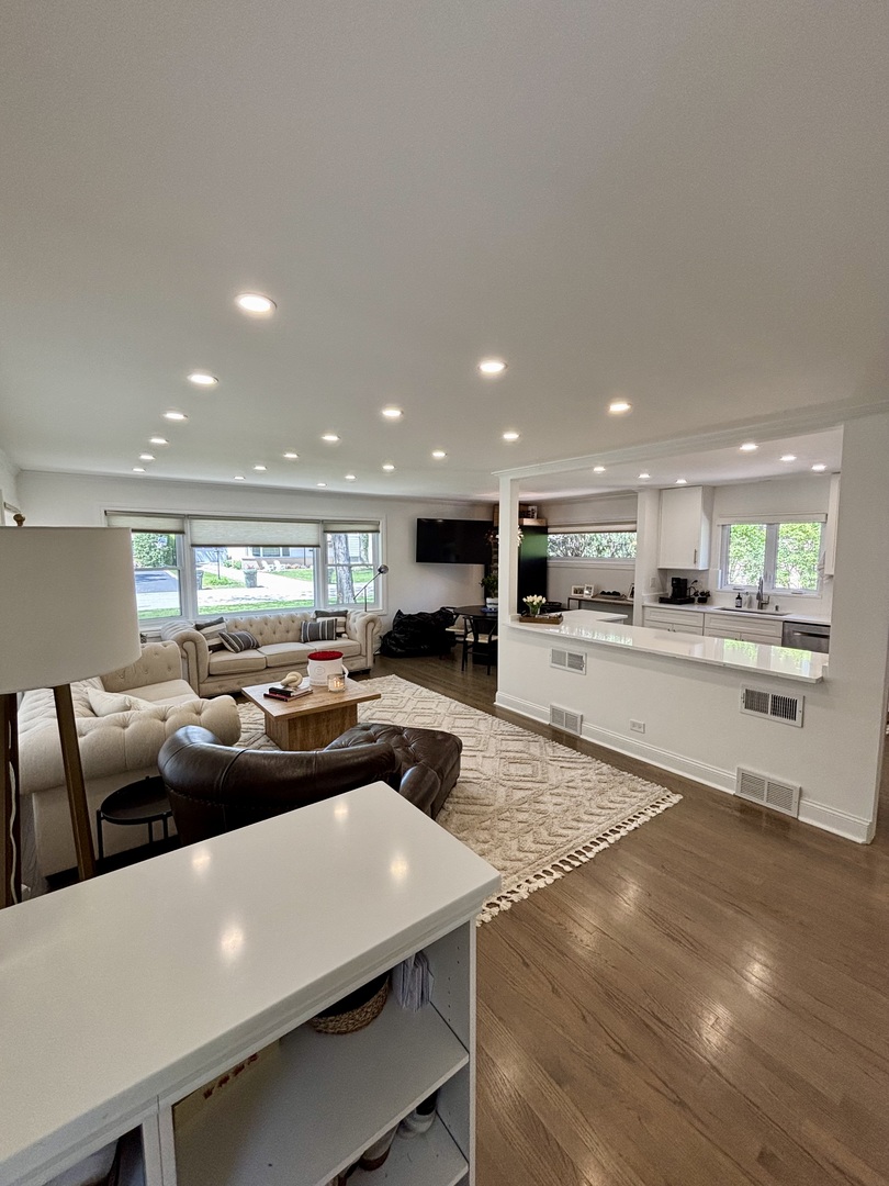 1237 Heatherfield Lane Glenview, IL 60025 - Photo 9 of 33 a living room with couches and kitchen view with wooden floor