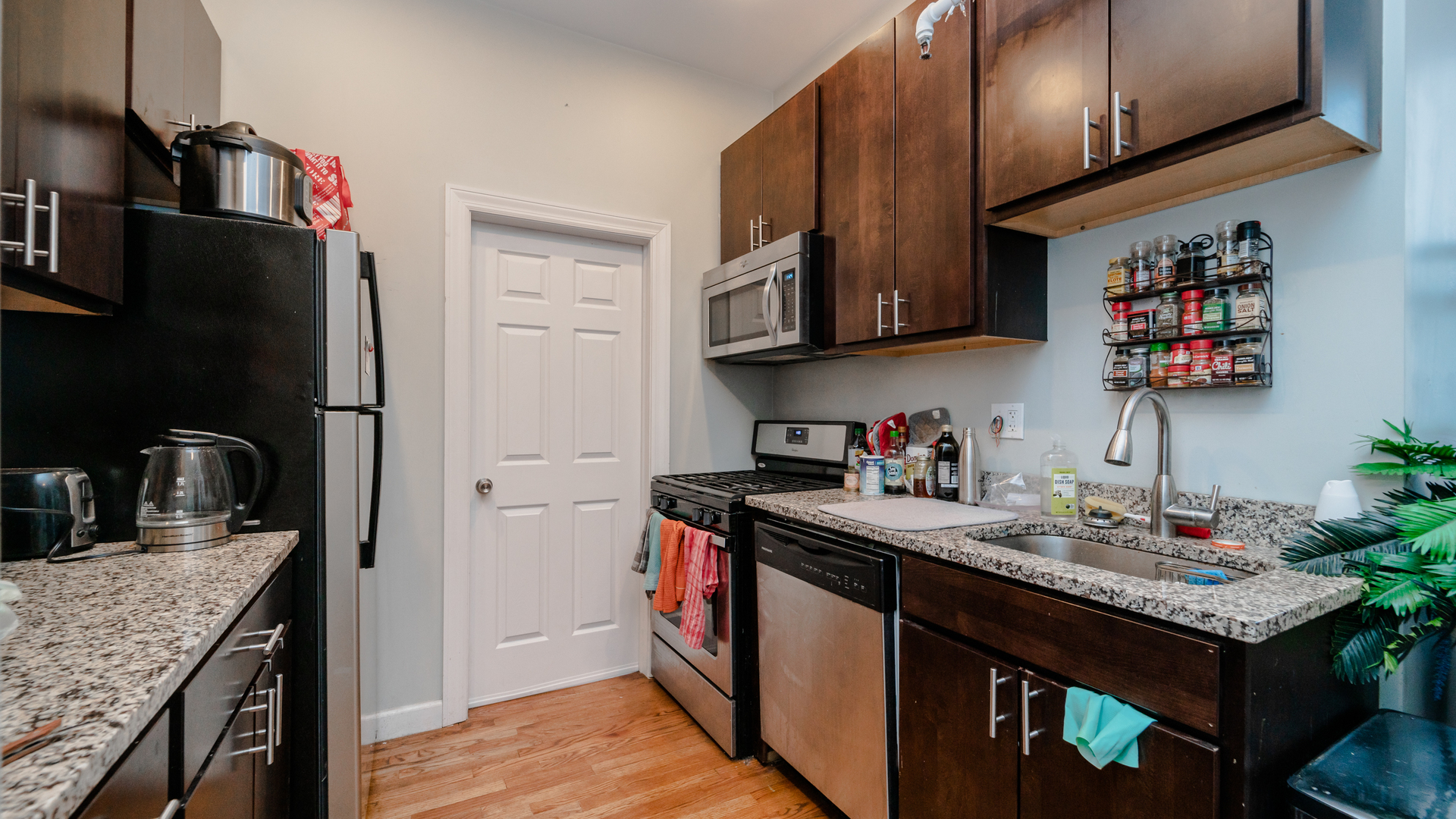 656 West Belden Avenue, Unit 202 Chicago, IL 60614 - Photo 5 of 14 a kitchen with stainless steel appliances granite countertop a sink stove and refrigerator