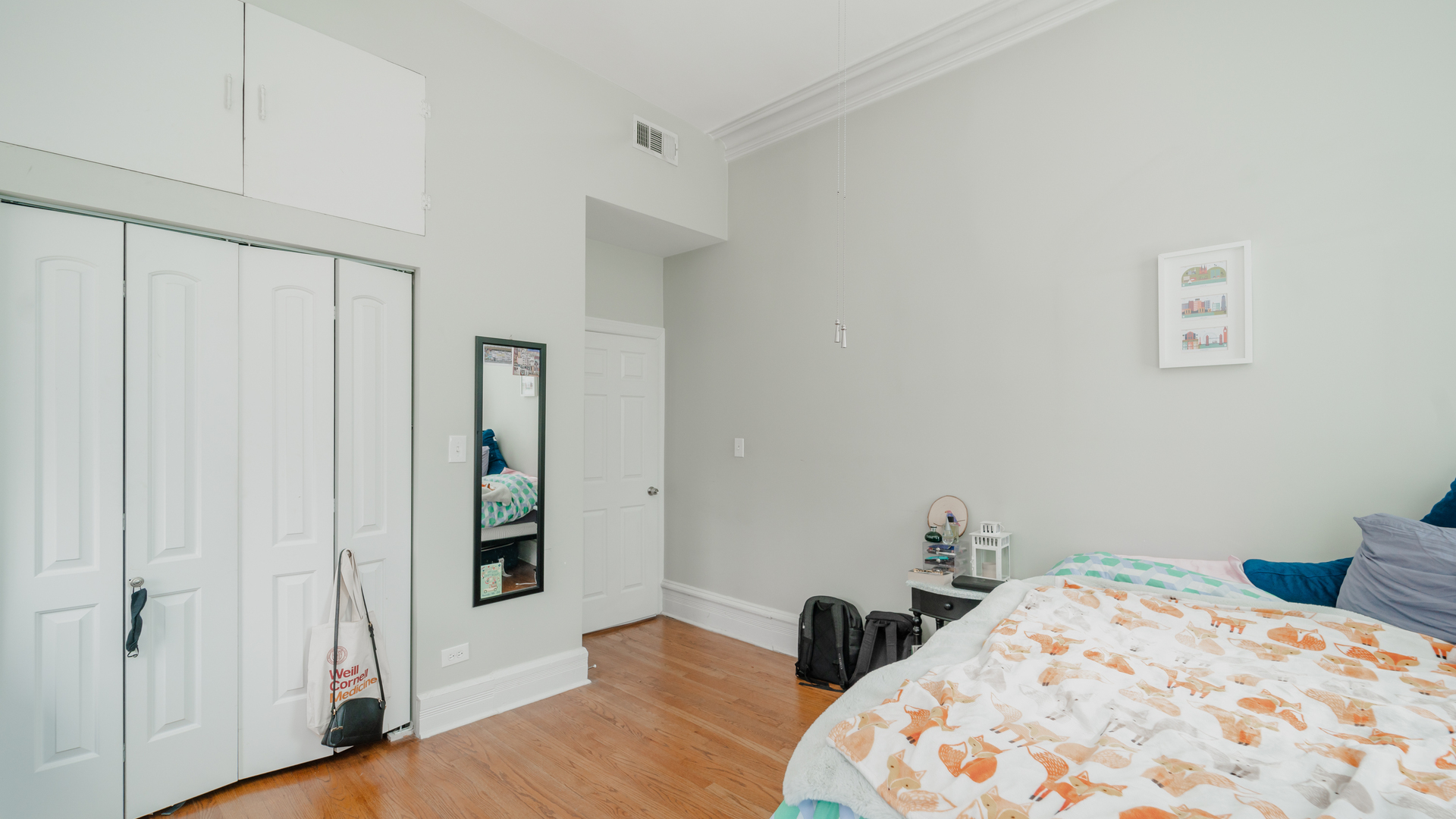 656 West Belden Avenue, Unit 202 Chicago, IL 60614 - Photo 9 of 14 a bedroom with a bed and wooden floor
