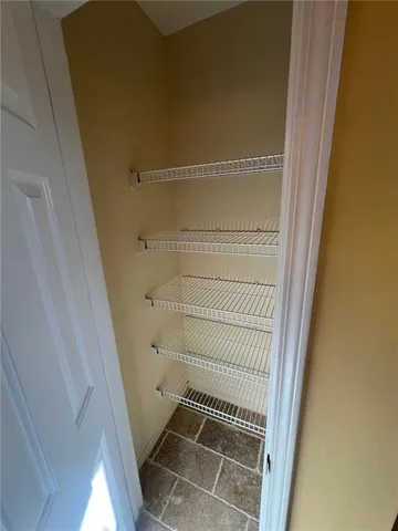 a view of storage and utility room with a door