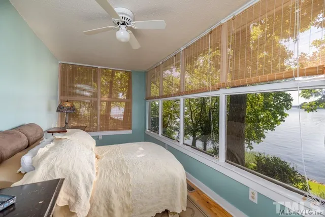 a bed sitting in a bedroom next to a window