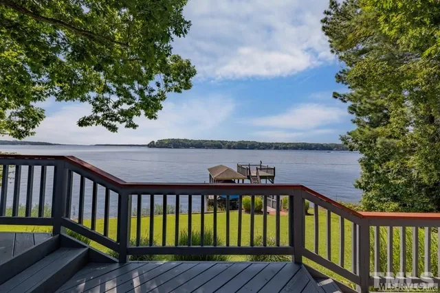 a view of balcony with wooden floor and fence