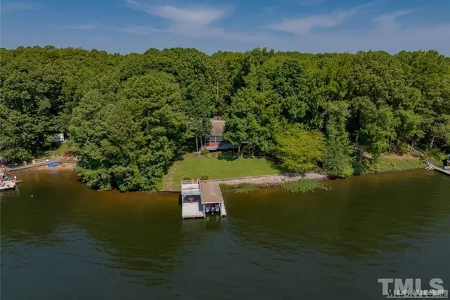 a front view of a house with a yard table and chairs