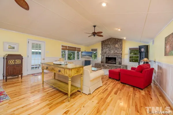 a living room with fireplace furniture and a wooden floor
