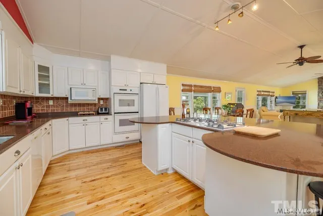 a kitchen with stainless steel appliances granite countertop a sink and cabinets
