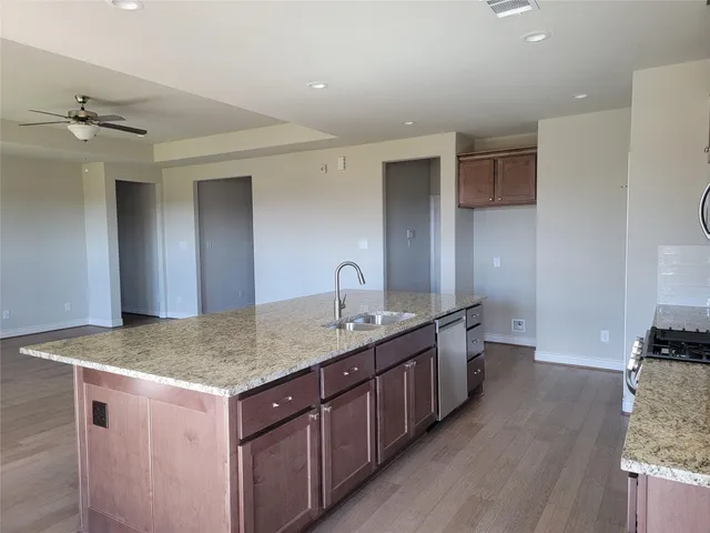a bathroom with a granite countertop sink a large mirror and vanity