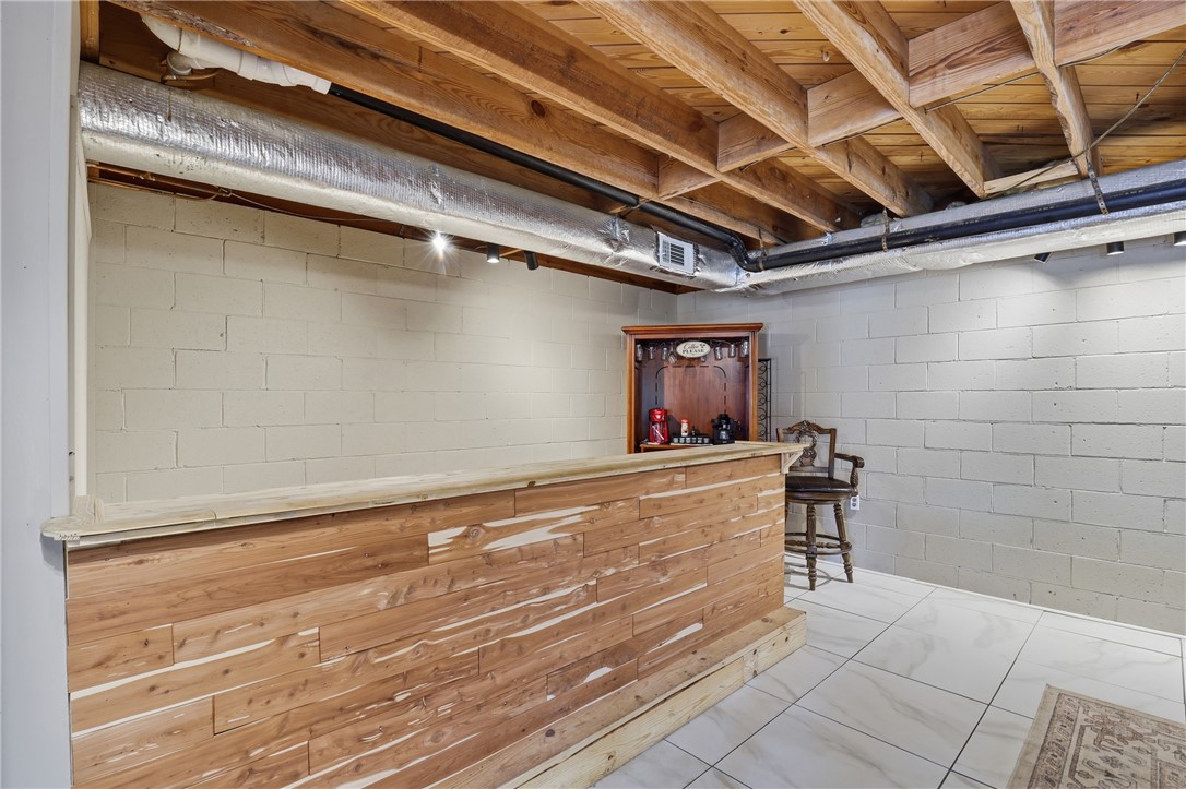 4304 Old Buncombe Road Greenville, SC 29617 - Photo 28 of 49 This versatile basement space features a custom bar and durable tile flooring, perfect for entertainment or relaxation.