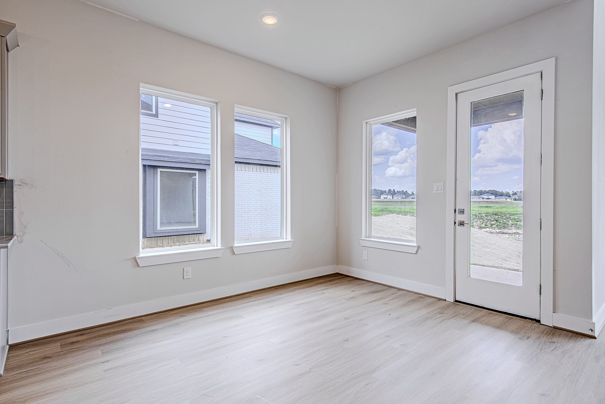 181 Peninsula Point Drive Montgomery, TX 77356 - Photo 12 of 44 Enjoy dining with a view—this breakfast area is wrapped in windows and offers direct patio access, blending indoor comfort with outdoor potential.