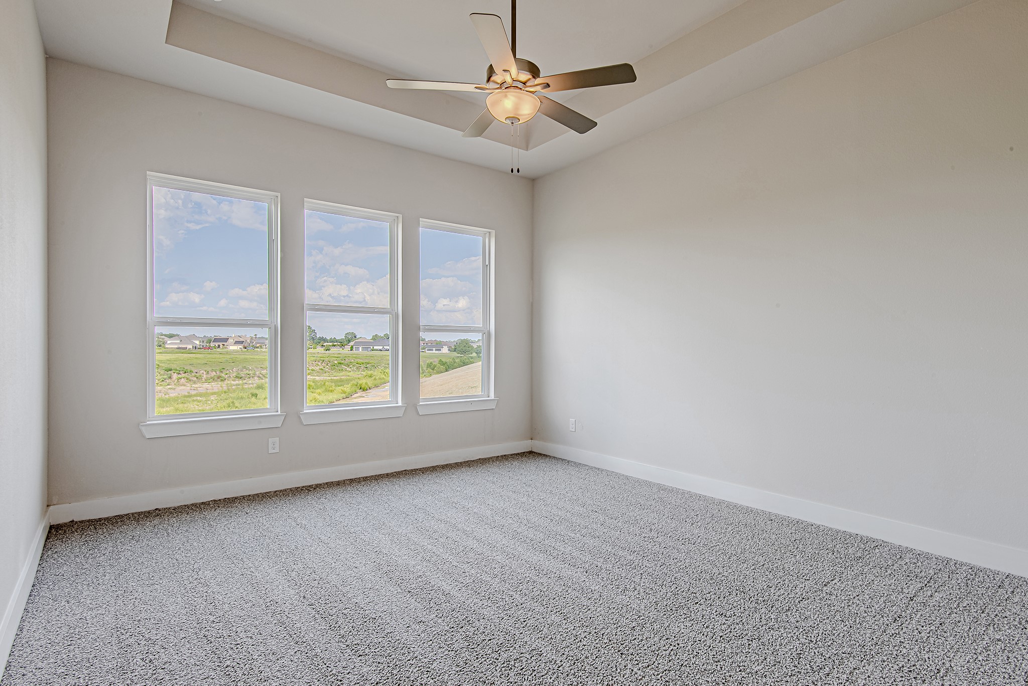 181 Peninsula Point Drive Montgomery, TX 77356 - Photo 16 of 44 Wake up to natural light pouring in through oversized windows in this serene primary suite with tray ceilings and backyard views.