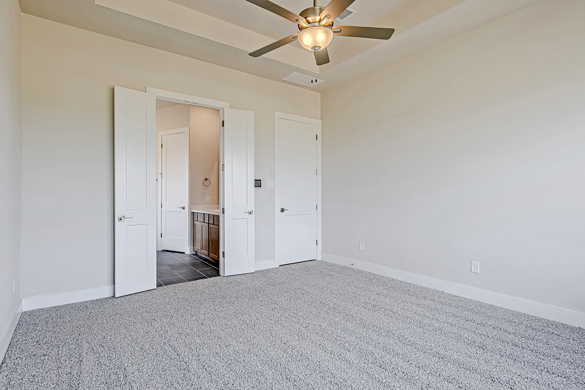 181 Peninsula Point Drive Montgomery, TX 77356 - Photo 17 of 44 Soft carpet underfoot and neutral tones create a restful retreat, complete with double doors leading to the en suite bath.