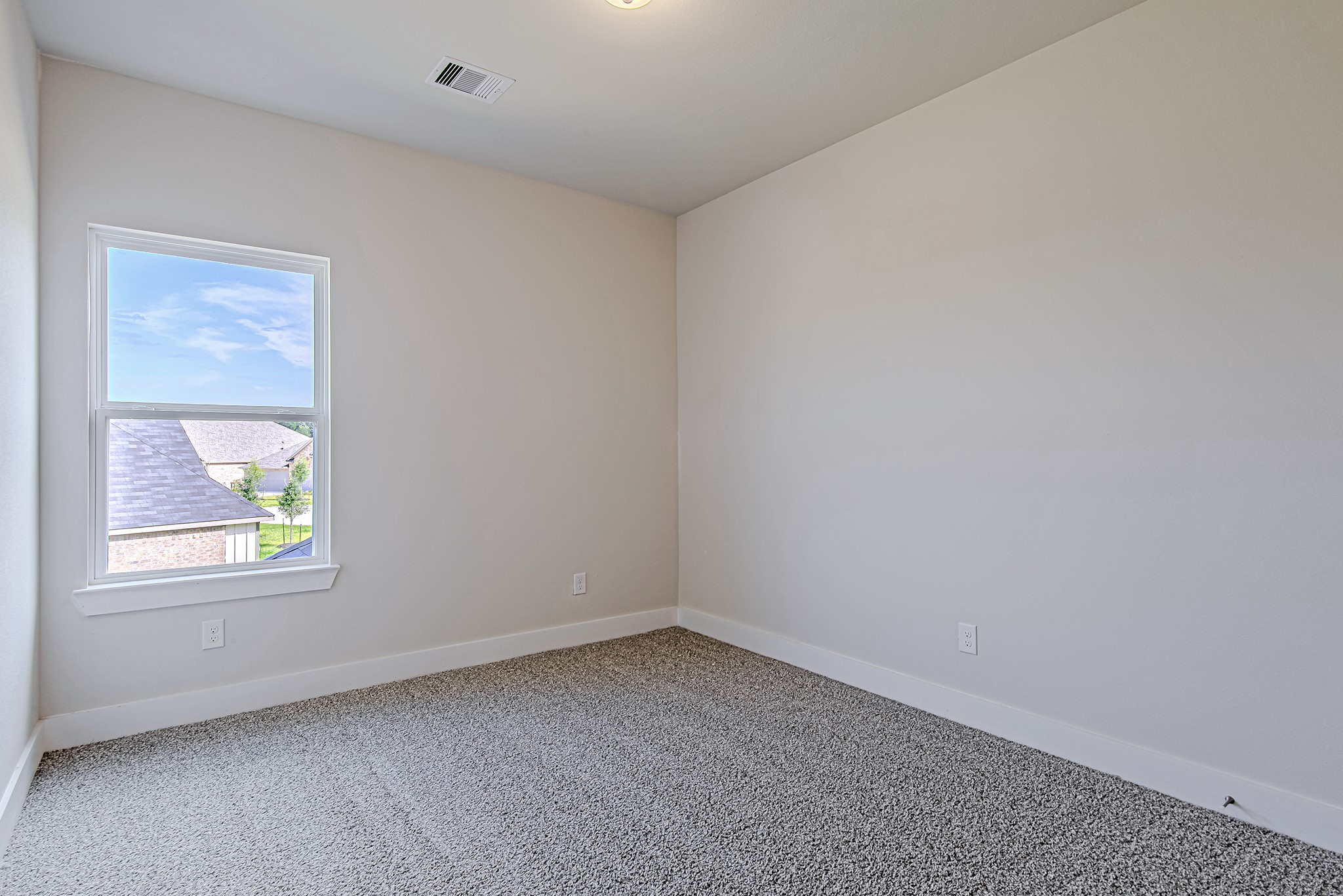 181 Peninsula Point Drive Montgomery, TX 77356 - Photo 28 of 44 A cozy secondary bedroom featuring soft neutral tones, plush carpeting, and a large window that frames the sky beautifully.