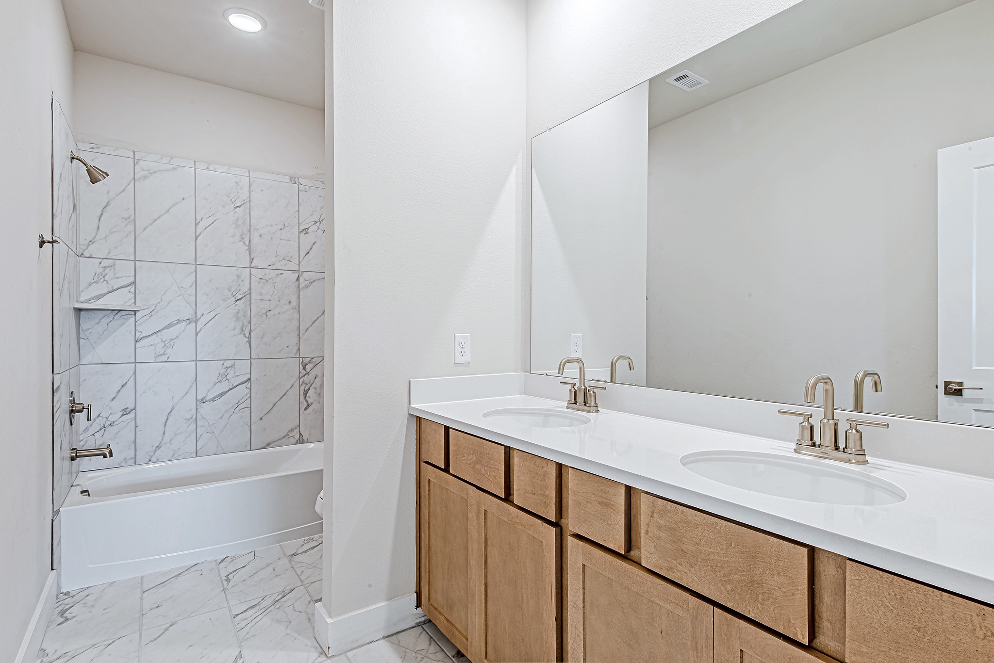 181 Peninsula Point Drive Montgomery, TX 77356 - Photo 29 of 44 The upstairs full bathroom features a large double vanity with sleek fixtures and modern lighting—perfect for sharing without sacrificing space.