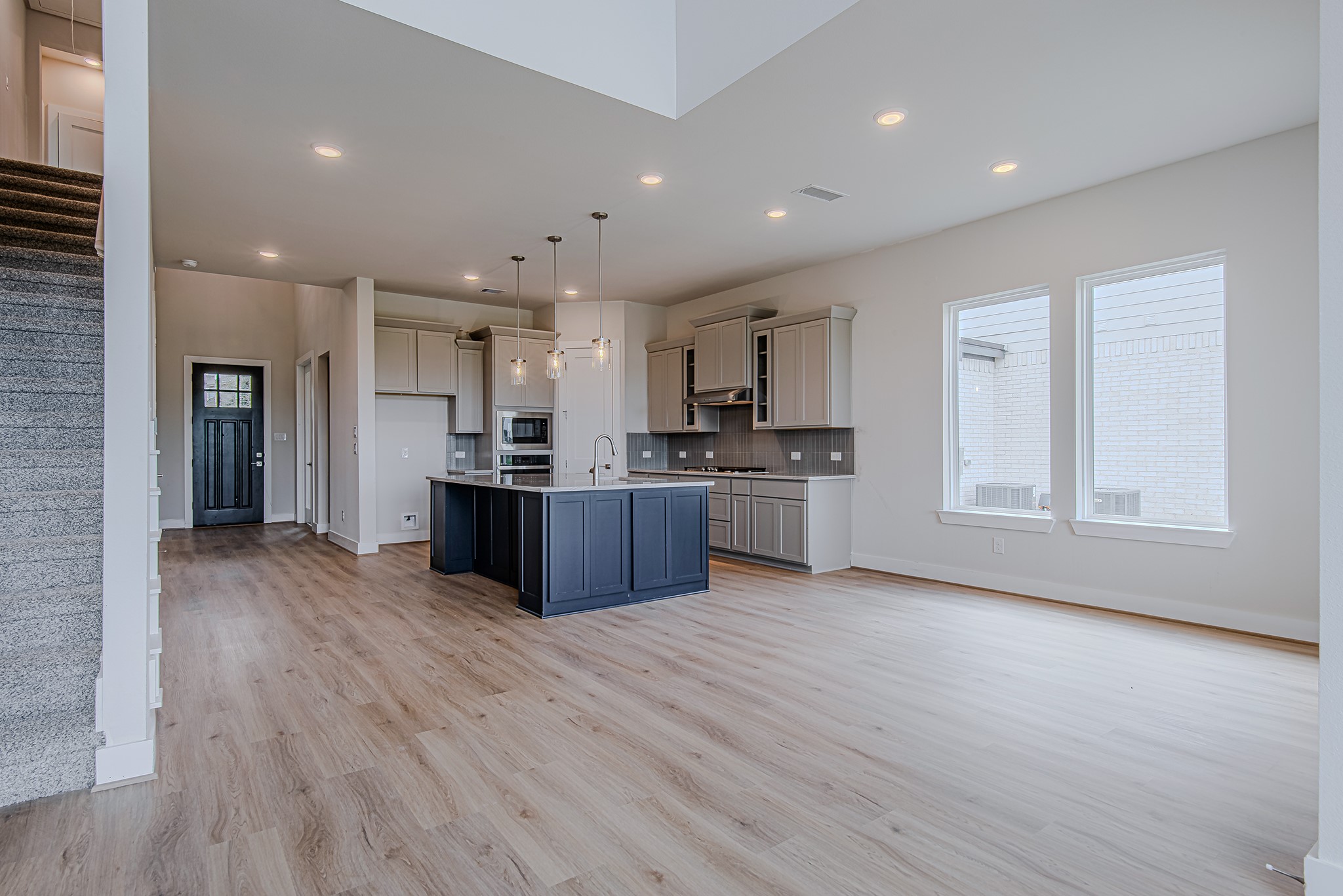 181 Peninsula Point Drive Montgomery, TX 77356 - Photo 9 of 44 Open-concept living at its finest—this light-filled space features soaring ceilings, warm wood-look flooring, and a seamless flow into the gourmet kitchen.
