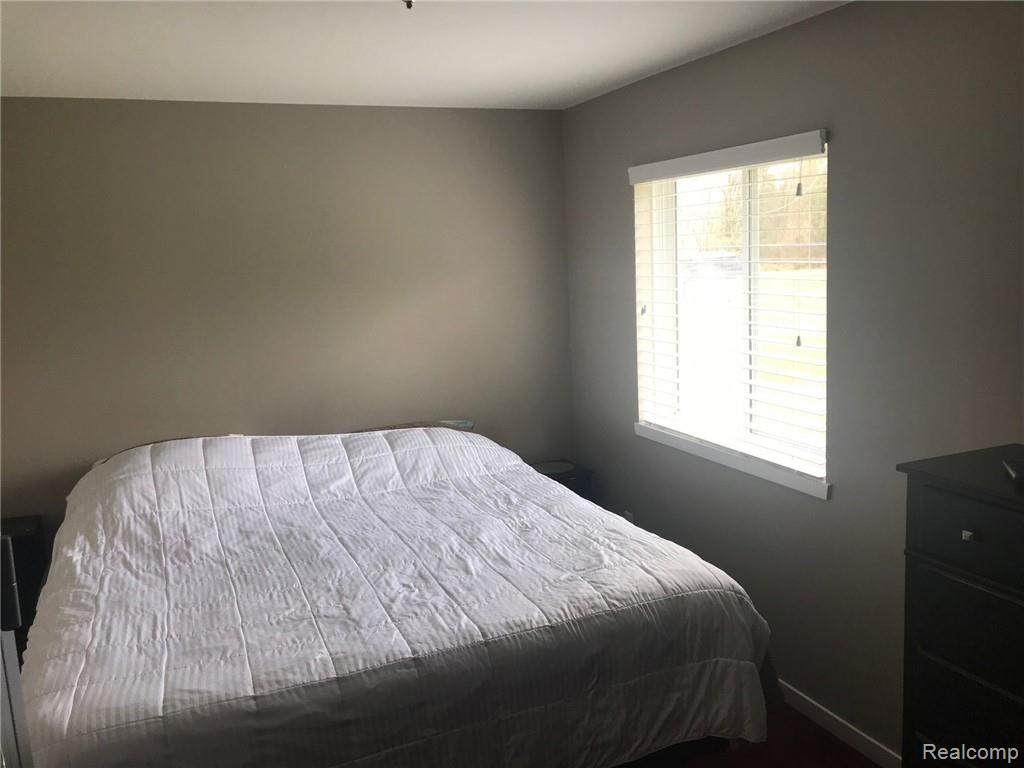 10068 West Sober Road Fowlerville, MI 48836 - Photo 9 of 23 Master Bedroom with adjoining bath