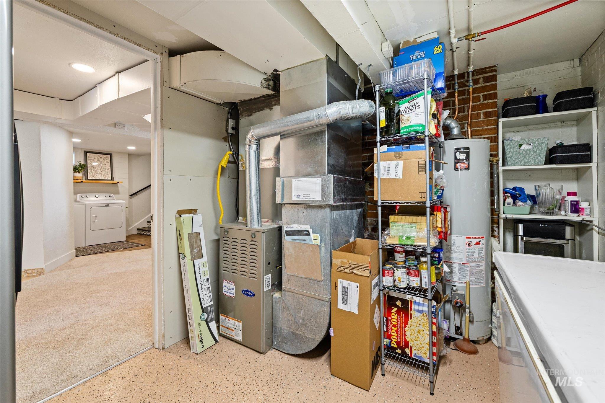 1008 Fillmore Street Caldwell, ID 83605 - Photo 12 of 50 Storage room with heating unit, water heater, and washer / dryer