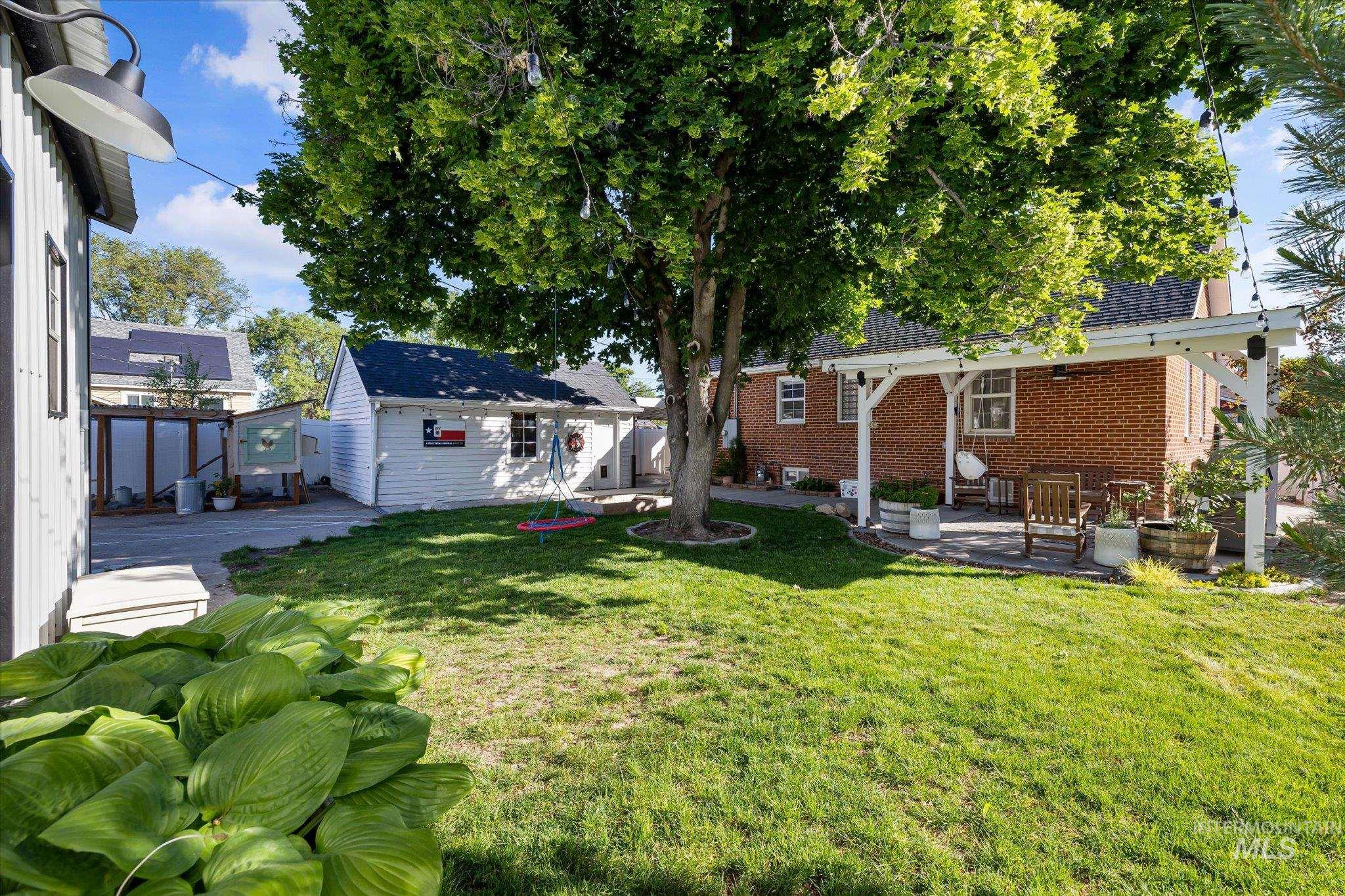 1008 Fillmore Street Caldwell, ID 83605 - Photo 15 of 50 View of grassy yard with an outbuilding and a patio area