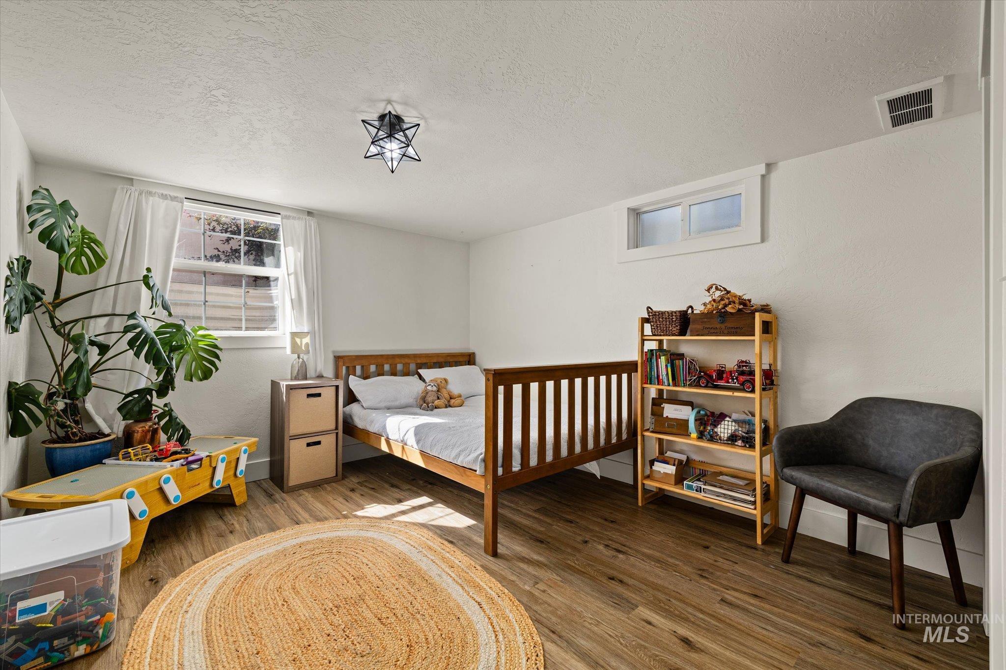 1008 Fillmore Street Caldwell, ID 83605 - Photo 18 of 50 Bedroom featuring a textured ceiling and wood finished floors