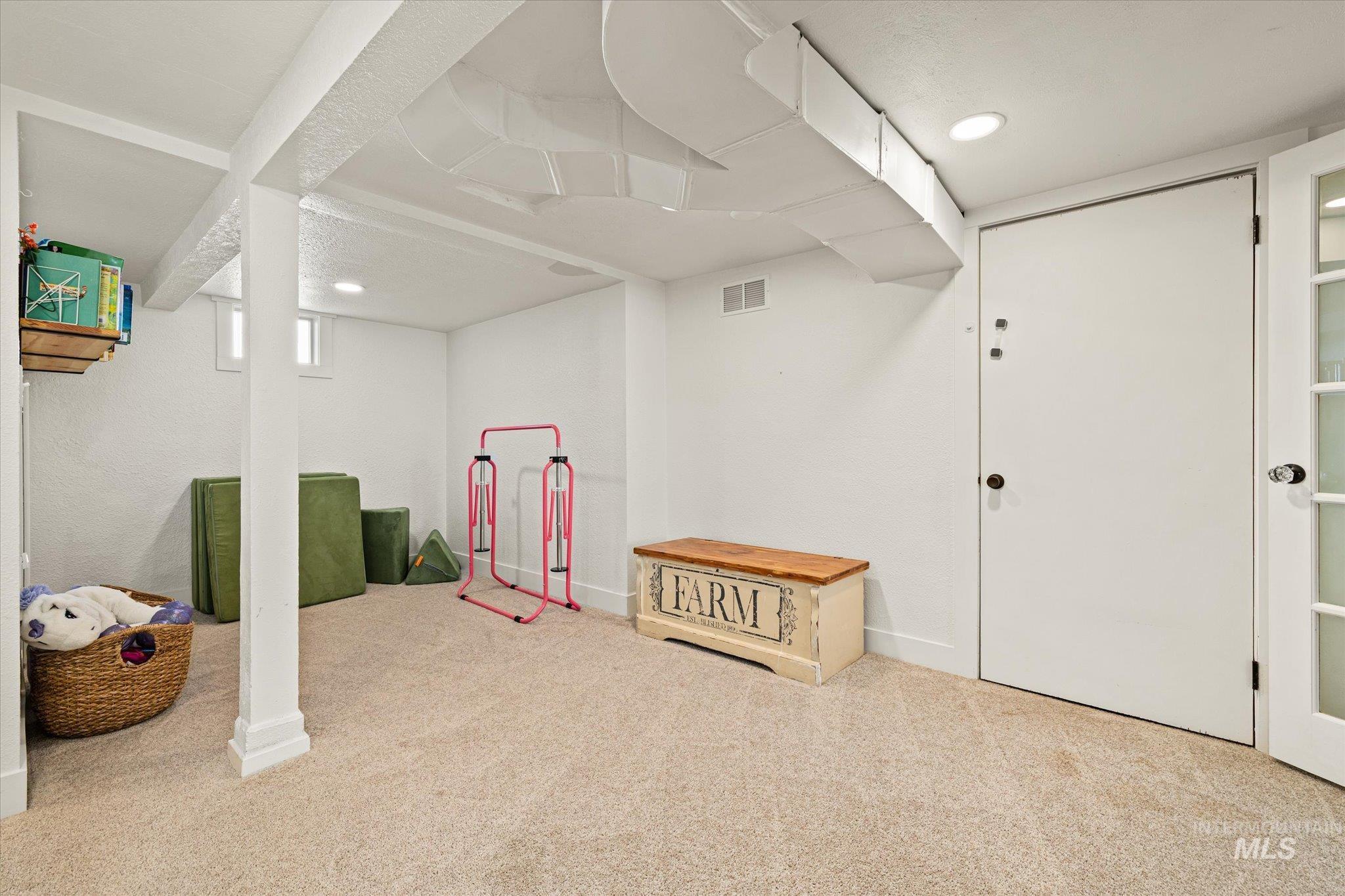 1008 Fillmore Street Caldwell, ID 83605 - Photo 26 of 50 Below grade area with light carpet and recessed lighting