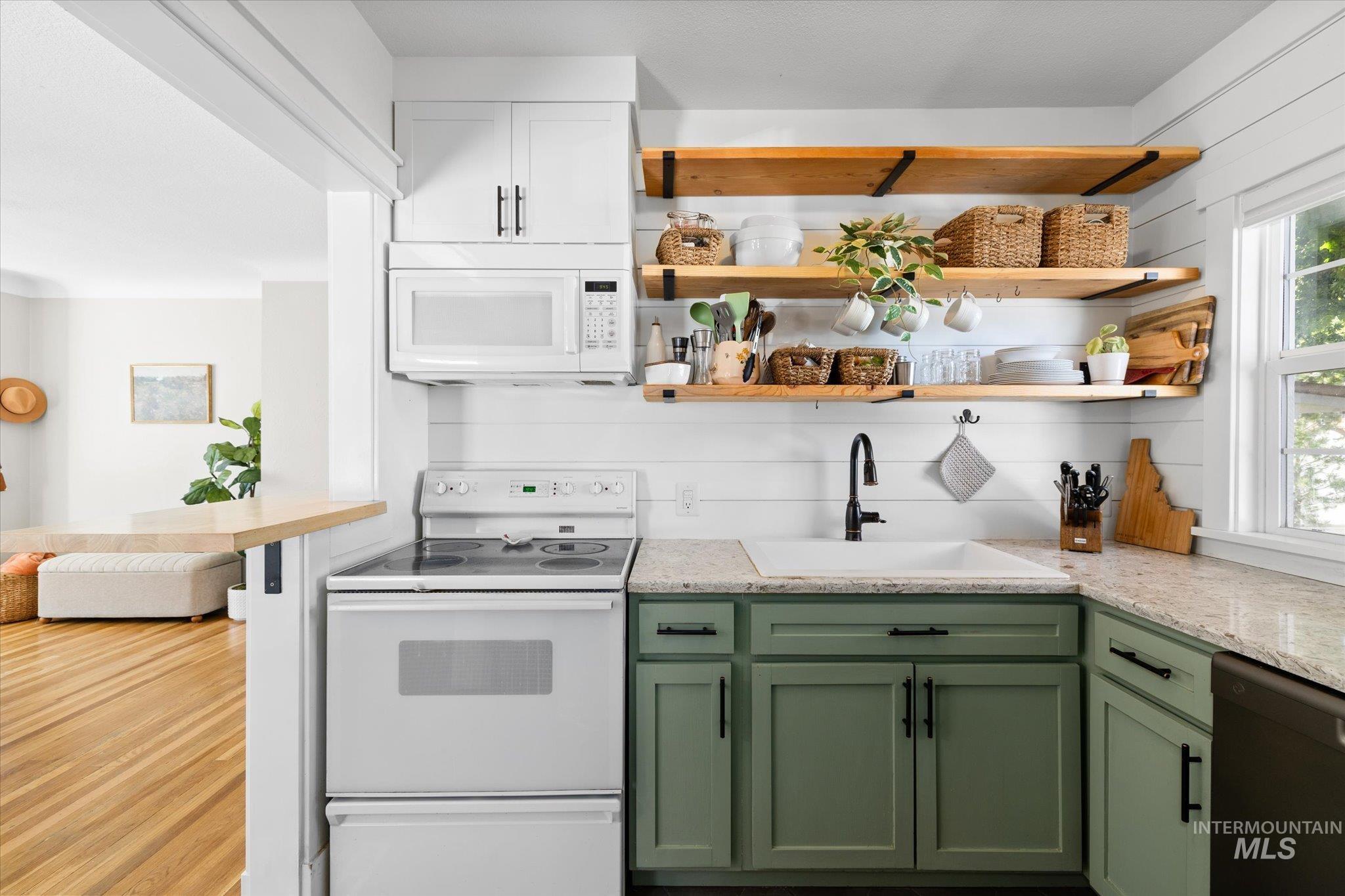1008 Fillmore Street Caldwell, ID 83605 - Photo 35 of 50 Kitchen featuring green cabinetry, white appliances, open shelves, and light stone counters
