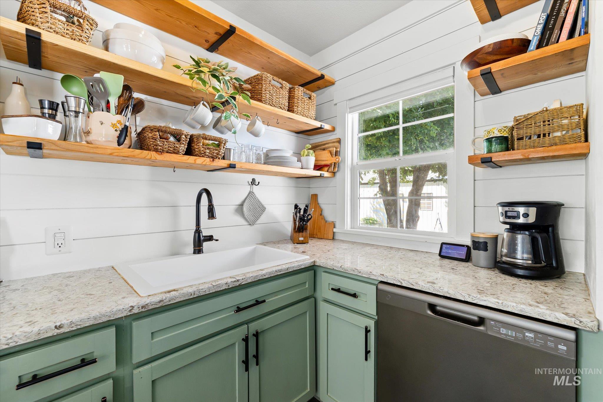 1008 Fillmore Street Caldwell, ID 83605 - Photo 36 of 50 Kitchen with green cabinetry, open shelves, dishwashing machine, and light stone countertops