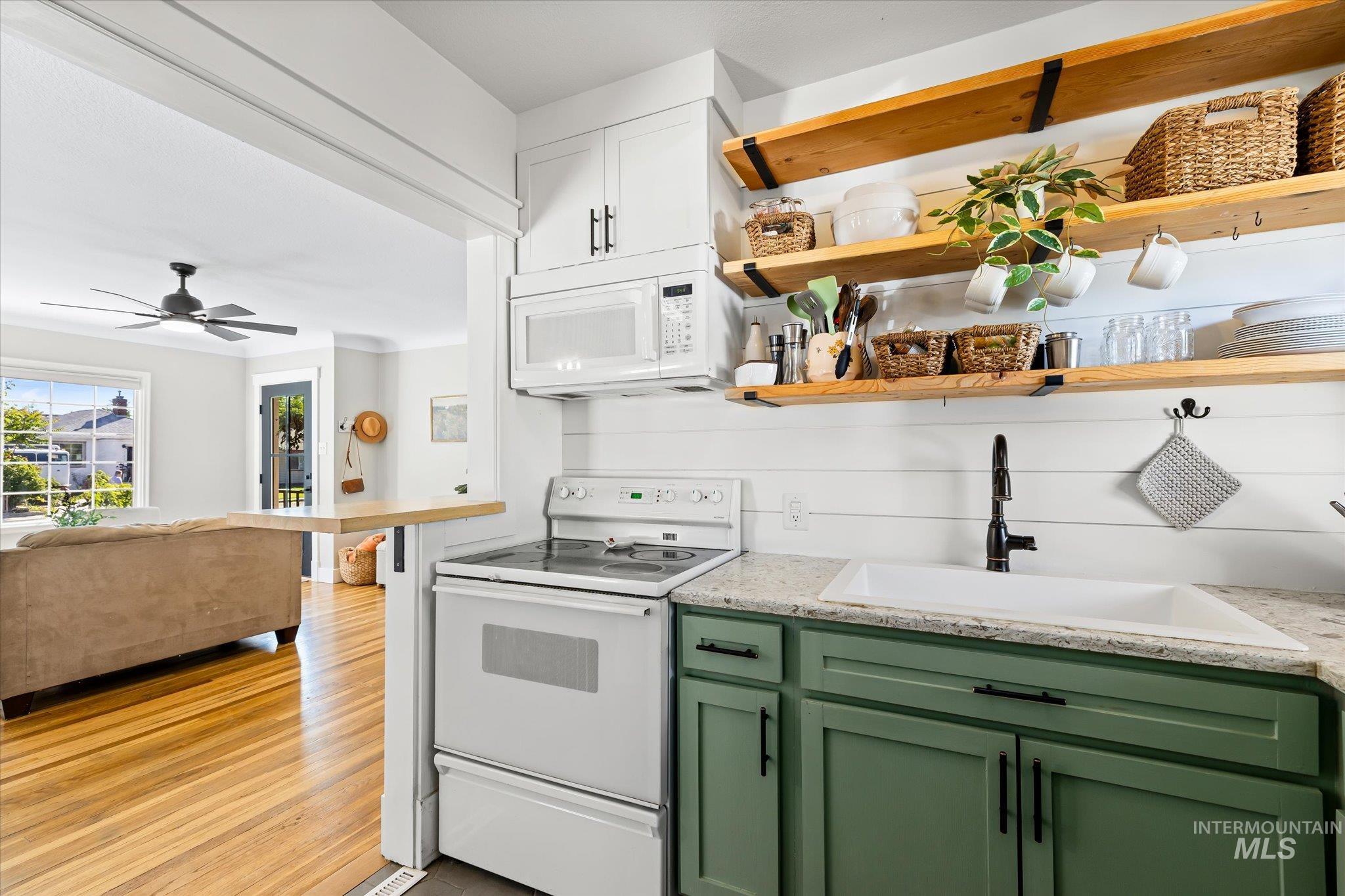 1008 Fillmore Street Caldwell, ID 83605 - Photo 50 of 50 Kitchen featuring white appliances, open floor plan, green cabinetry, open shelves, and ceiling fan