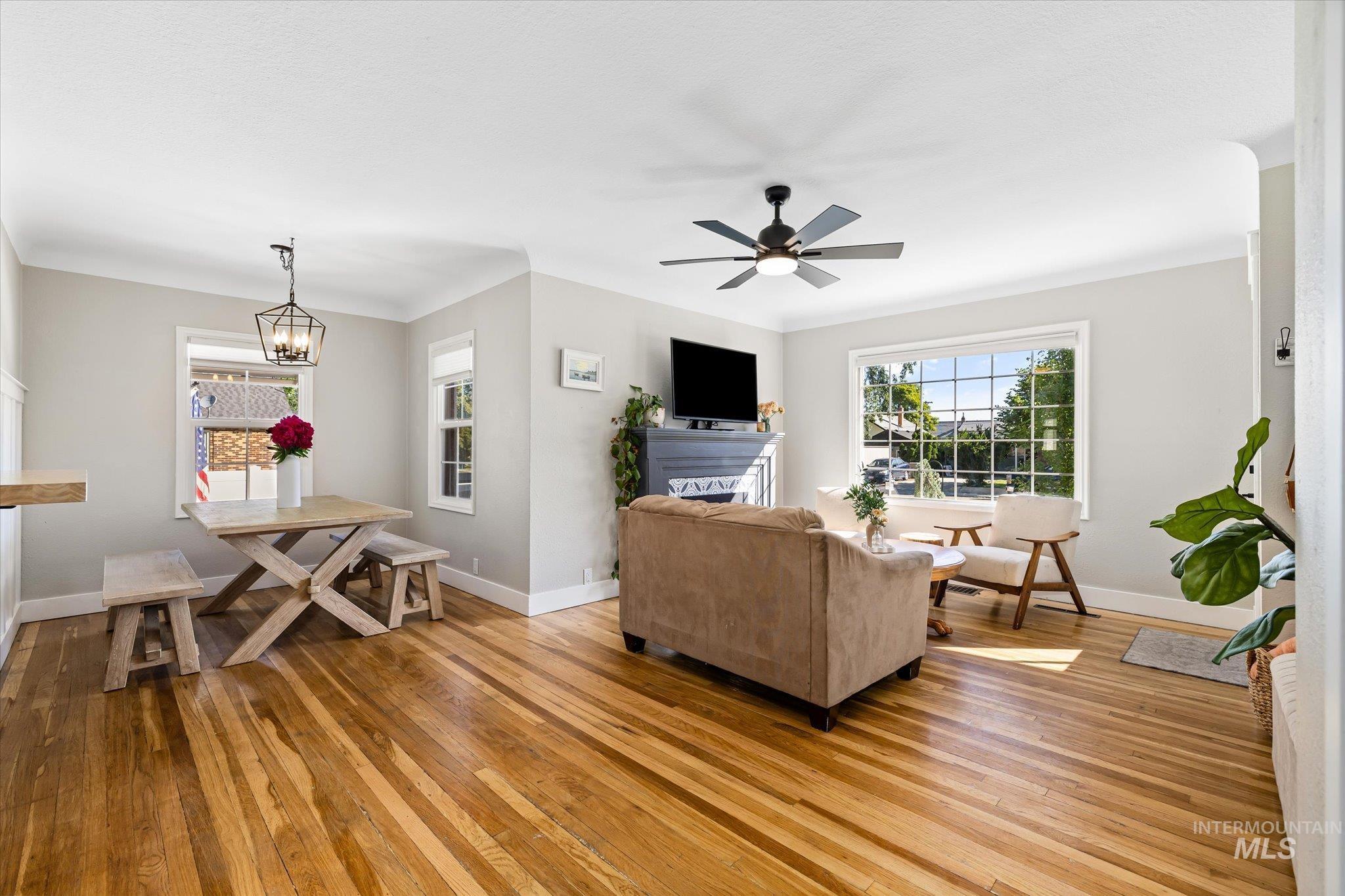 1008 Fillmore Street Caldwell, ID 83605 - Photo 38 of 50 Living area with light wood finished floors, ceiling fan, and a chandelier