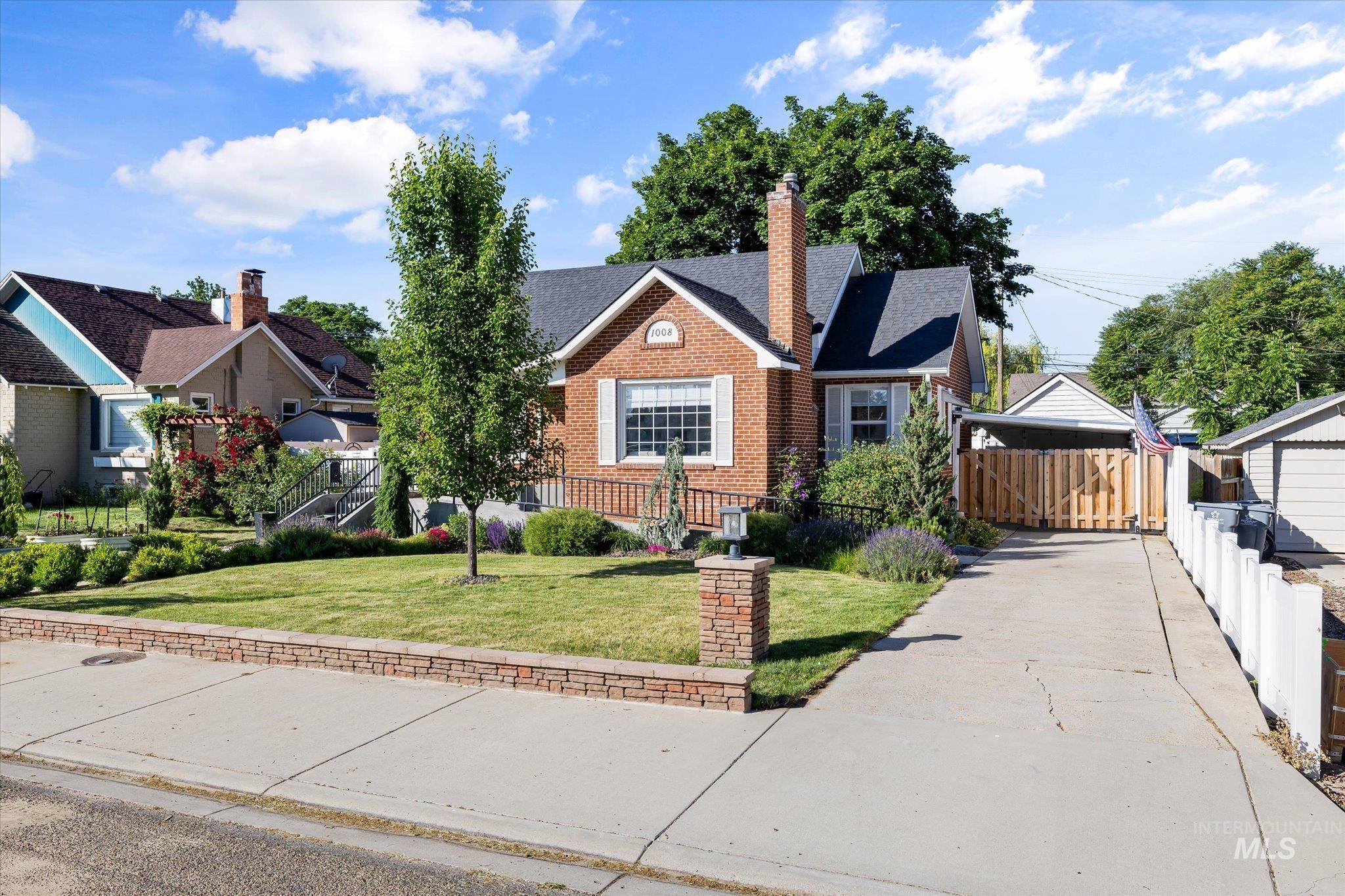 1008 Fillmore Street Caldwell, ID 83605 - Photo 49 of 50 View of front of home with a chimney, brick siding, and a shingled roof