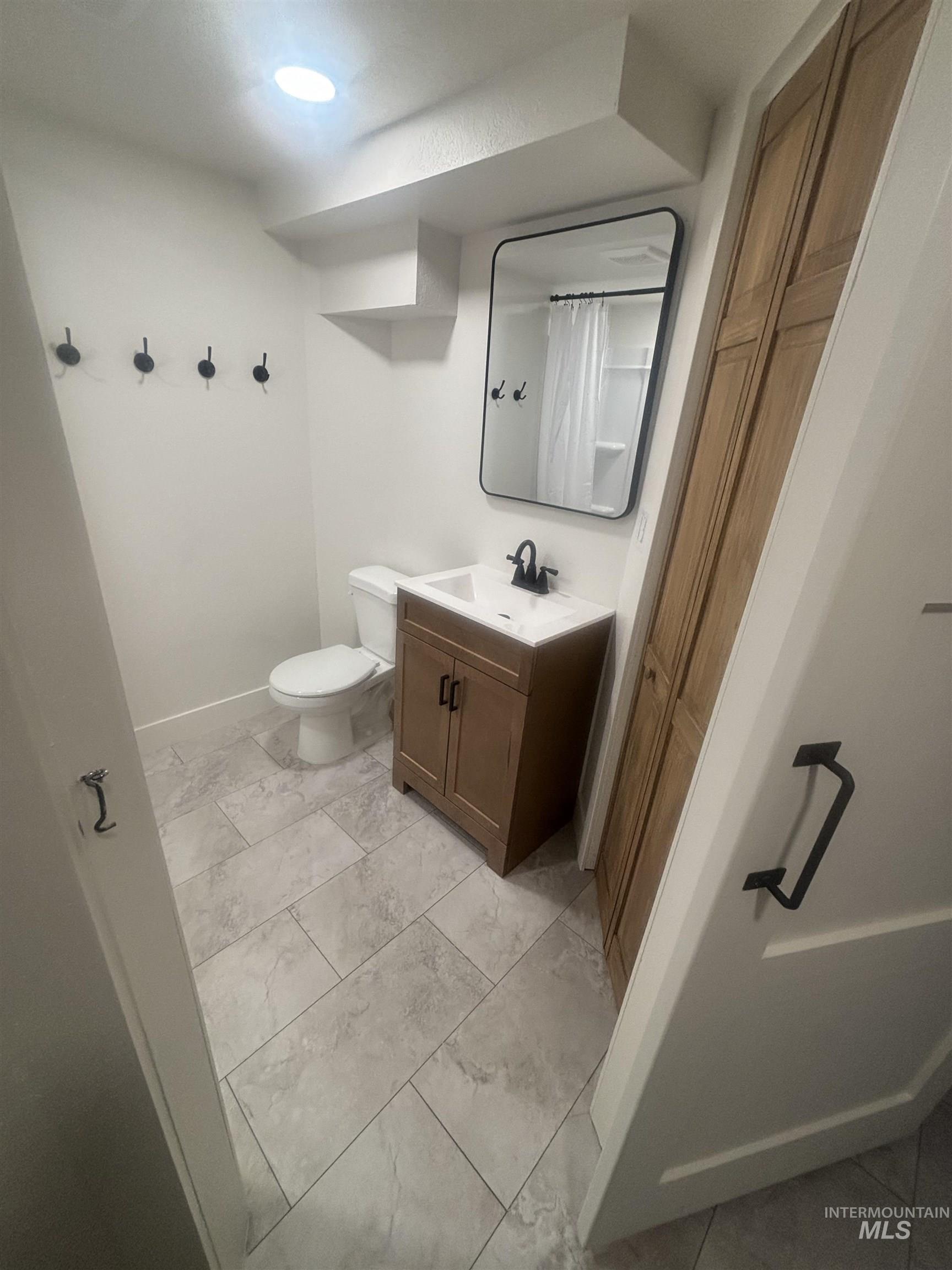 1008 Fillmore Street Caldwell, ID 83605 - Photo 10 of 50 Bathroom with vanity, a shower with shower curtain, and light marble finish floors