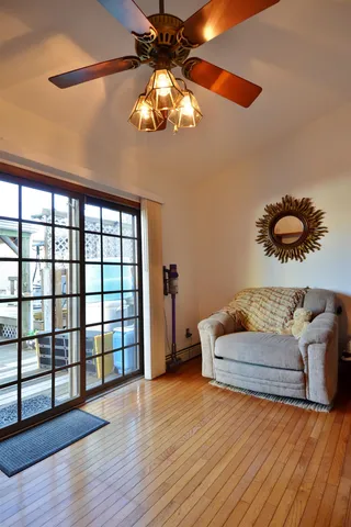 a living room with furniture and a floor to ceiling window