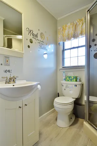 a bathroom with a sink toilet and window