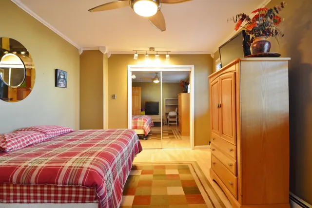 a bedroom with a bed and a mirror