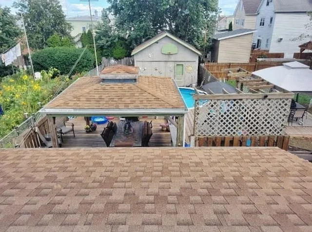 a view of a wooden chairs and table in the patio
