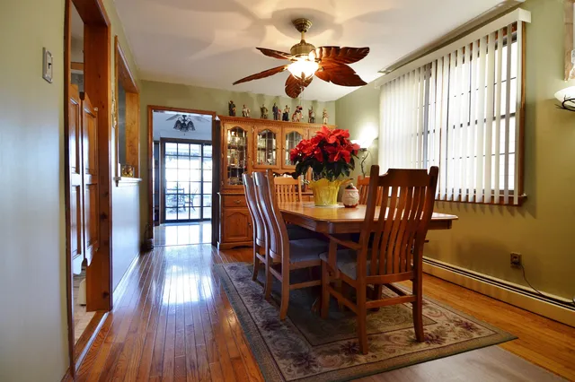 a view of a dining room with furniture and wooden floor