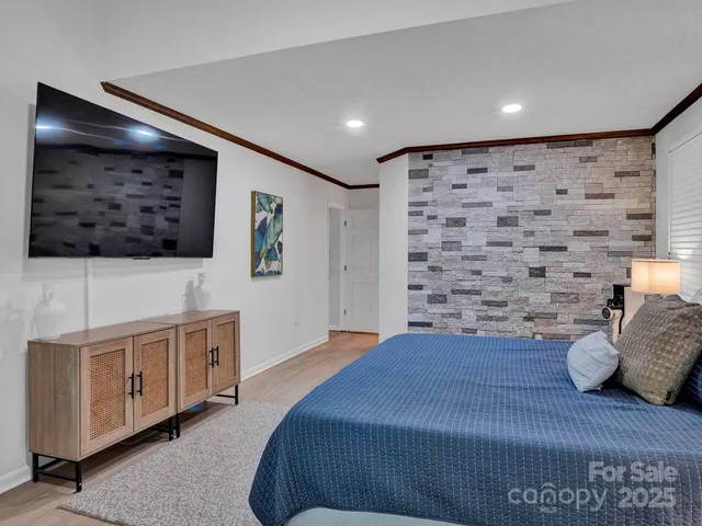 a bedroom with a bed and a flat screen tv