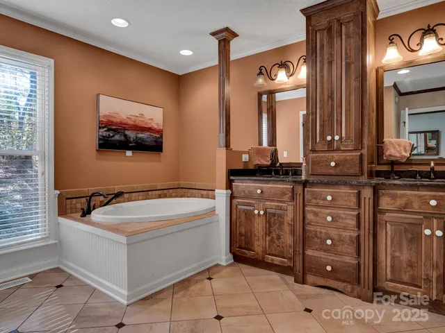 a bathroom with a sink a large mirror and a bathtub
