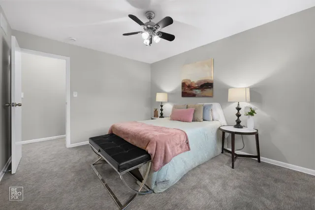 a bed room with a bed and a chair