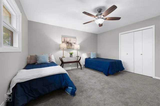 a bedroom with bed and a chandelier