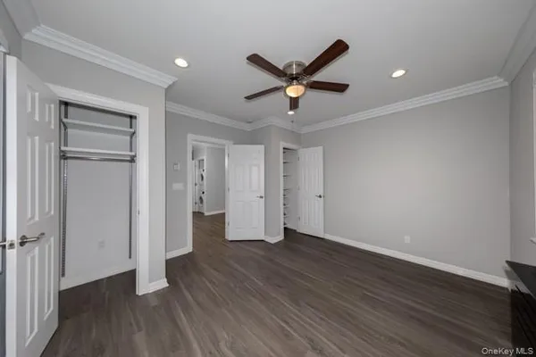 a view of empty room with wooden floor and window