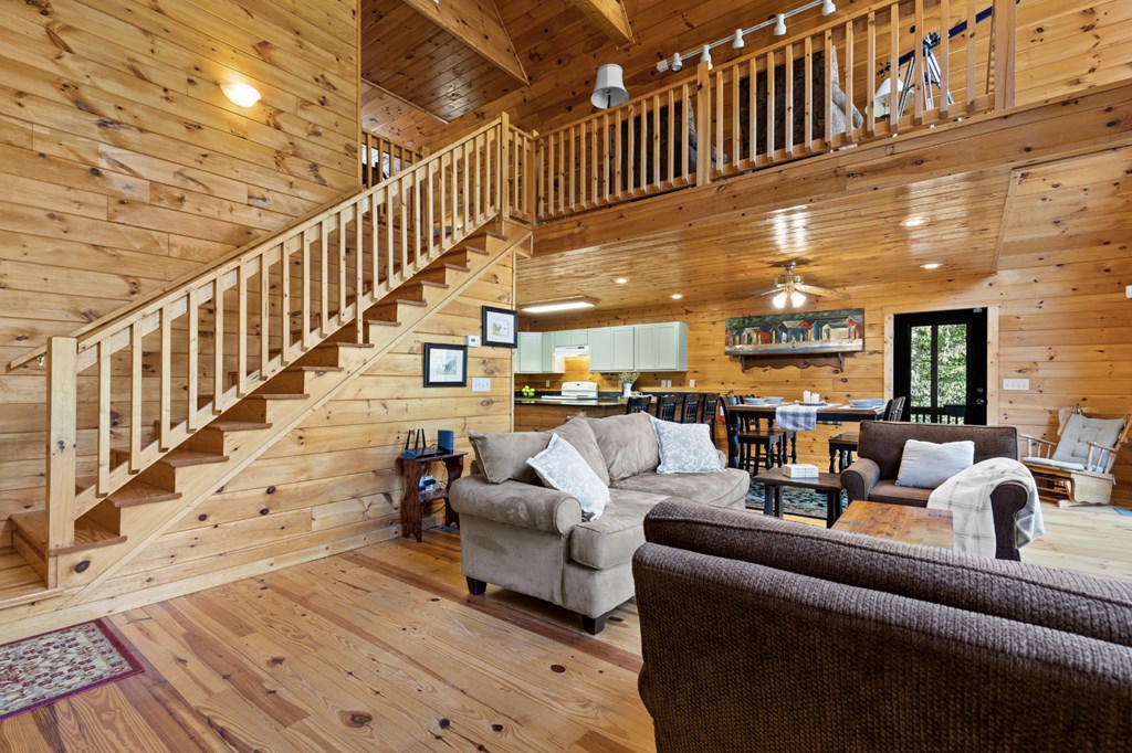 96 Holiday Court Ellijay, GA 30540 - Photo 12 of 51 a living room with furniture or stairs and a rug